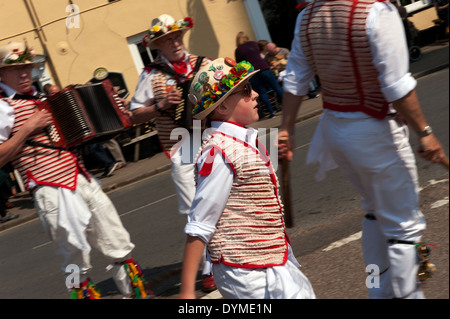 Thaxted Morris Men, in red and white, and Devil's Dyke Morris perform in the Bullring, Thaxted, Essex,England, on a glorious sun Stock Photo