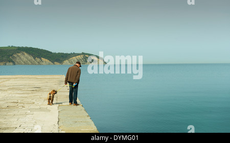 the man on the quay with his dog Stock Photo