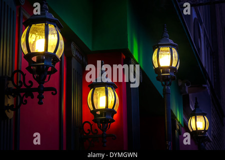 Vintage street lamps at the evening on red wall background Stock Photo