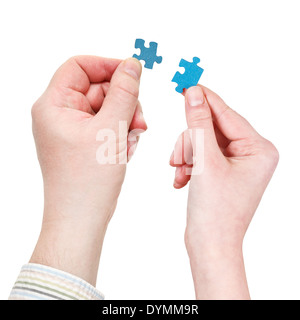 male and female two hands with little puzzle pieces isolated on white background Stock Photo