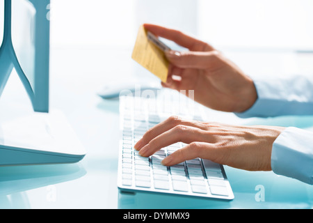 Woman Shopping on internet using computer and credit card Stock Photo