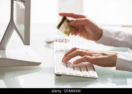 Woman Shopping on internet using computer and credit card