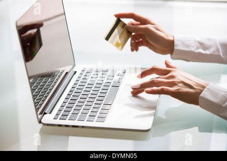 Woman shopping on internet using laptop and credit card