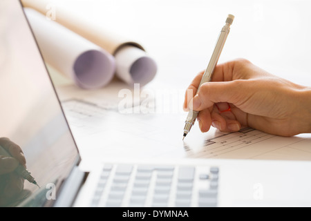 Woman Architect drawing on print construction Project Stock Photo