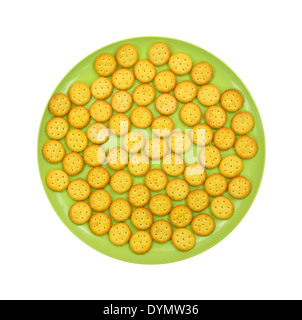A group of small snack crackers on a large green plate. Stock Photo