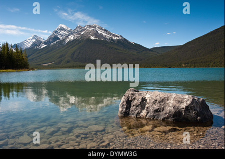Mountains reflecting in a lake in the sunshine Stock Photo