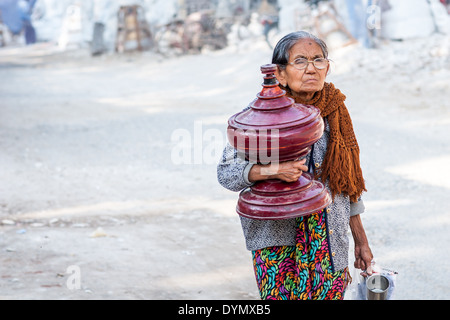 Old woman carrying an earn and shopping on the street of Mandalay, Myanmar Stock Photo