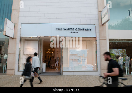 Shoppers walk past the shopfront of the lifestyle store The White Company in up-market Cabot Circus shopping area in Bristol Stock Photo