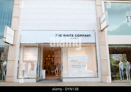 Shoppers walk past the shopfront of the lifestyle store The White Company in up-market Cabot Circus shopping area in Bristol Stock Photo