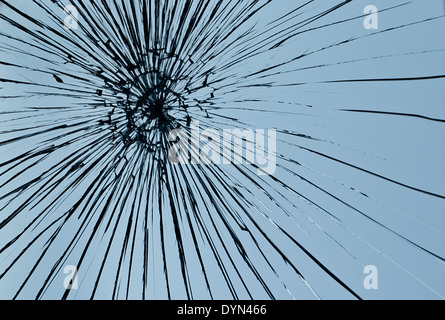 Cracked glass against a blue sky background Stock Photo