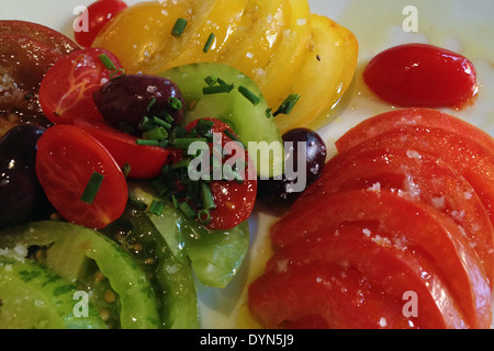 heirloom tomato salad on a white plate Stock Photo