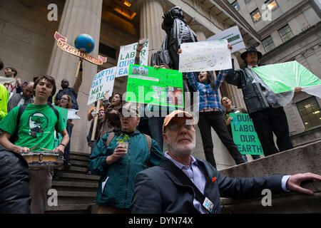 New York, USA. 22nd April 2014. Environmental activists attend a protest in Zuccotti Park on Earth Day. Protesters brought plants, and chanted ' System Change Not Climate Change, ' taking aim at large corporations who do not adhere to environmental concerns. These protesters also expressed that capatilisim exploitation of nature is the flip side to exploitation of human labor. Credit:  Scott Houston/Alamy Live News Stock Photo