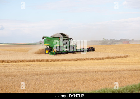 John Deere combine harvesting a crop of wheat in Pierce County, North Dakota Stock Photo