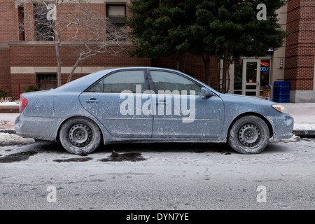 Car covered in dried road salt brine - USA Stock Photo