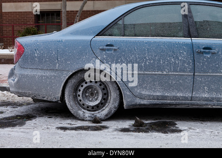 Car covered in dried road salt brine - USA Stock Photo