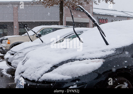 Raised car windshield wipers during snow storm - USA Stock Photo