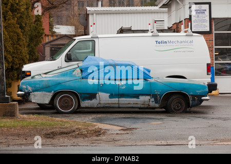 Run-down 1968 Plymouth Barracuda Coupe car covered with tarp - USA Stock Photo