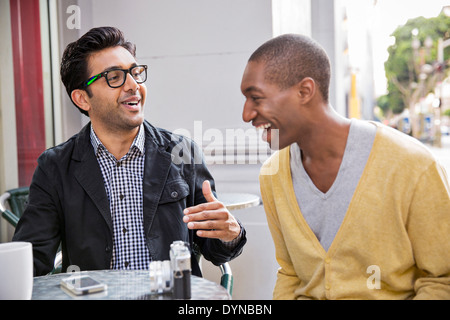 Men talking at sidewalk cafe Stock Photo