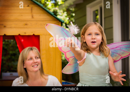 Mother and daughter in playhouse