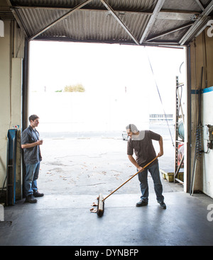 Workers talking at warehouse loading dock Stock Photo