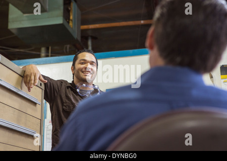 Worker and manager talking in warehouse Stock Photo
