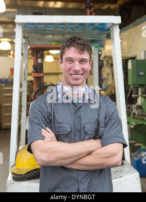 Caucasian worker smiling in warehouse Stock Photo