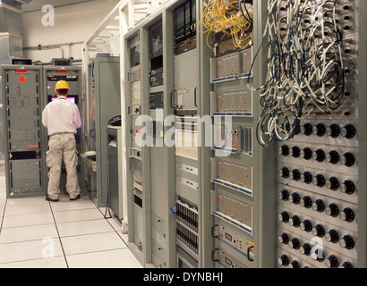 Computer programmer working in server room Stock Photo
