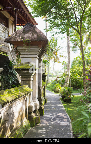 Pathway along moss covered stone building Stock Photo