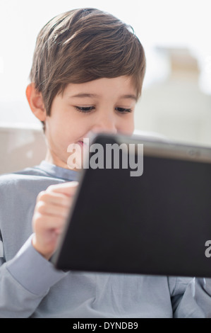 Hispanic boy using digital tablet Stock Photo
