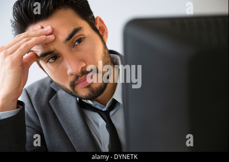 Mixed race businessman working in office Stock Photo