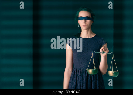 Lady Justice (Justitia) blindfolded holding waight scale. Concept image of law and being equal. Stock Photo