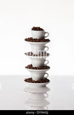 Pile of four coffee  cups filled with coffee roasted beans Stock Photo