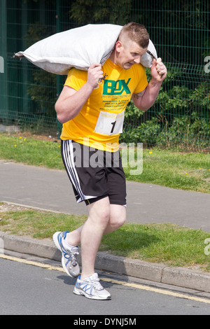World Coal Carrying Championship, Gawthorpe, West Yorkshire, Easter Monday 2014.  male contestant running the race Stock Photo