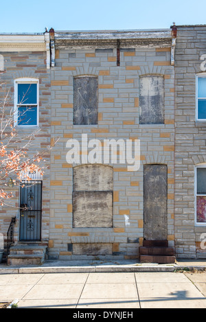 boarded up row home in Baltimore, MD Stock Photo