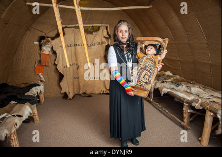 Piscataway Native American woman holding doll baby in Waldorf MD Stock Photo