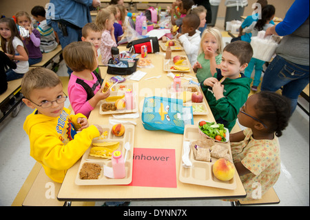 Elementary school children sitting at tables having lunch in a cafeteria Hagerstown, Maryland Stock Photo
