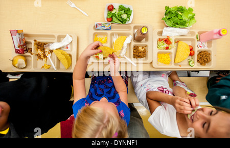 Elementary school children sitting at tables having lunch in a cafeteria Hagerstown, Maryland Stock Photo