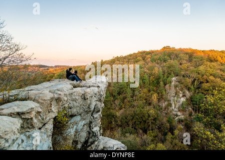 Man and woman on King and Queens Seat rock formation at Rocks State Park in Maryland Stock Photo