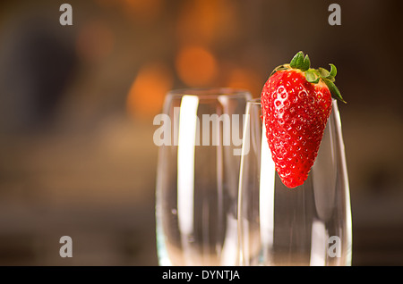 Empty champagne glasses with a strawberry. Stock Photo