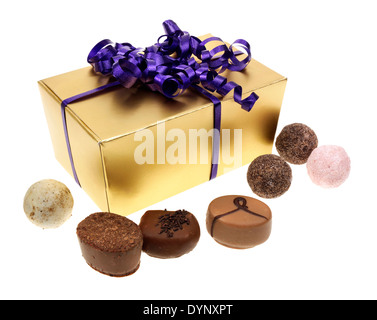 A CUTOUT OF GOLD BOX OF ASSORTED TRUFFLE CHOCOLATES WITH PRETTY PURPLE RIBBON Stock Photo