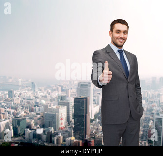 handsome buisnessman showing thumbs up Stock Photo