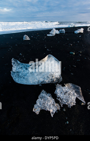 Packs of ice ejected derived from the Vatnajokull glacier are returned by the Atlantic ocean to the beach of Jokullsarlon, Iceland Stock Photo