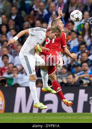 Madrid, Spain. 23rd Apr, 2014. Defender Fabio Coentrao of Real Madrid (L) duels for a high ball with Bastian SCHWEINSTEIGER during the UEFA Champions League Game between Real Madrid and FC Bayern Munich at Santiago Bernabeu Stadium, Valencia Credit:  Action Plus Sports/Alamy Live News Stock Photo