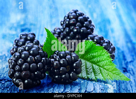 Blackberry fruit with leaf on old wood background Stock Photo