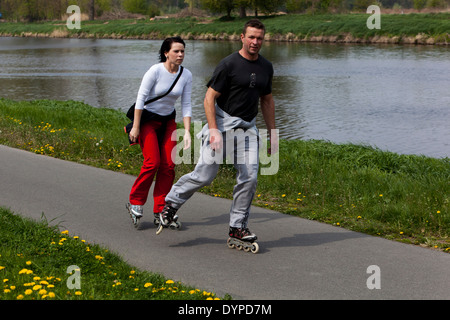 Active people use leisure time on roller skating cycle path Stock Photo