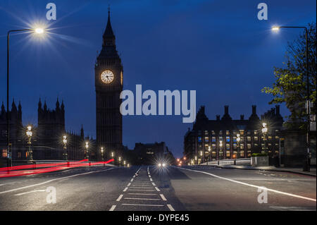 London ,UK. 24th April 2014.  a car appears on Westminster Bridge before sunrise. Credit:  Piero Cruciatti/Alamy Live News Stock Photo