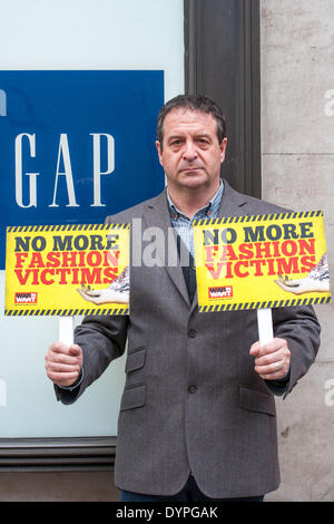 London, UK. 24th April 2014. . Comedian, Mark Thomas joined protesters outside Gap's flagship store in High Street Kensington. The protesters are angered that the company has refused to sign a legally binding accord after the Rana Plaza disaster in Bangladesh. The clothing shop's branch in High Street Kensington is alleged to be Kate Middleton's favourite Gap store where she has reportedly bought clothes for her son George and herself. The protest was held to support workers concerned they may make clothes for Gap in unsafe factories. Credit:  Pete Maclaine/Alamy Live News Stock Photo