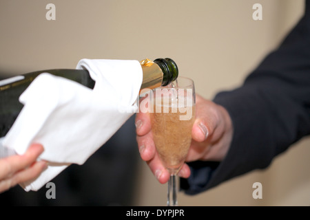 Veuve Durand champagne being poured into a champagne flute by a sommelier at a wedding Stock Photo