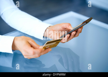 Woman shopping online using mobile phone and credit card .indoor.close-up Stock Photo