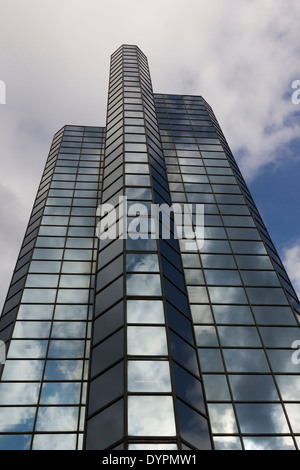 Tall glass fronted building in Glasgow near the Clyde, with cloud reflections in the glass. Stock Photo